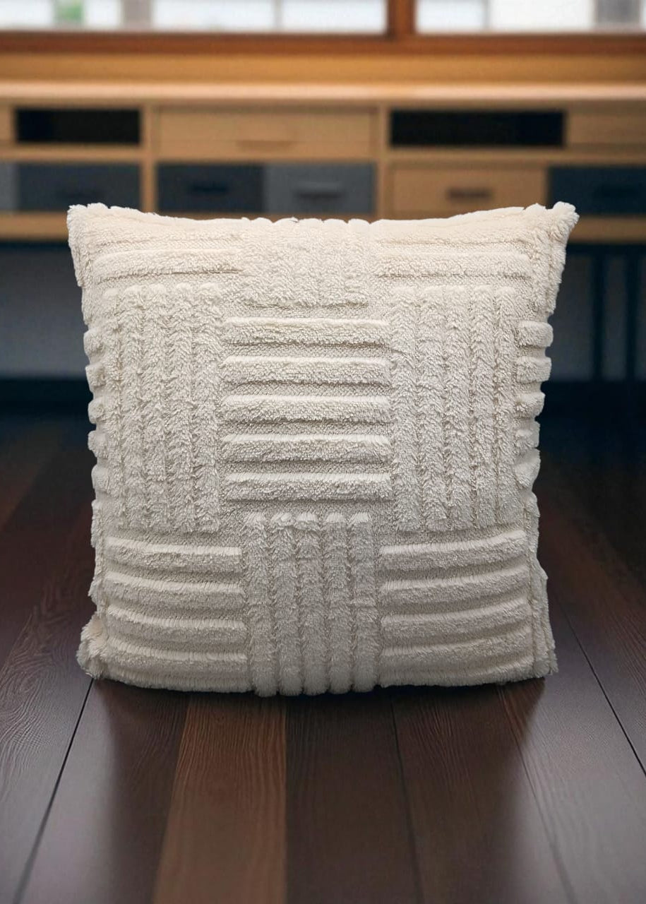 Textured white pillow on a wooden surface with a blurred background