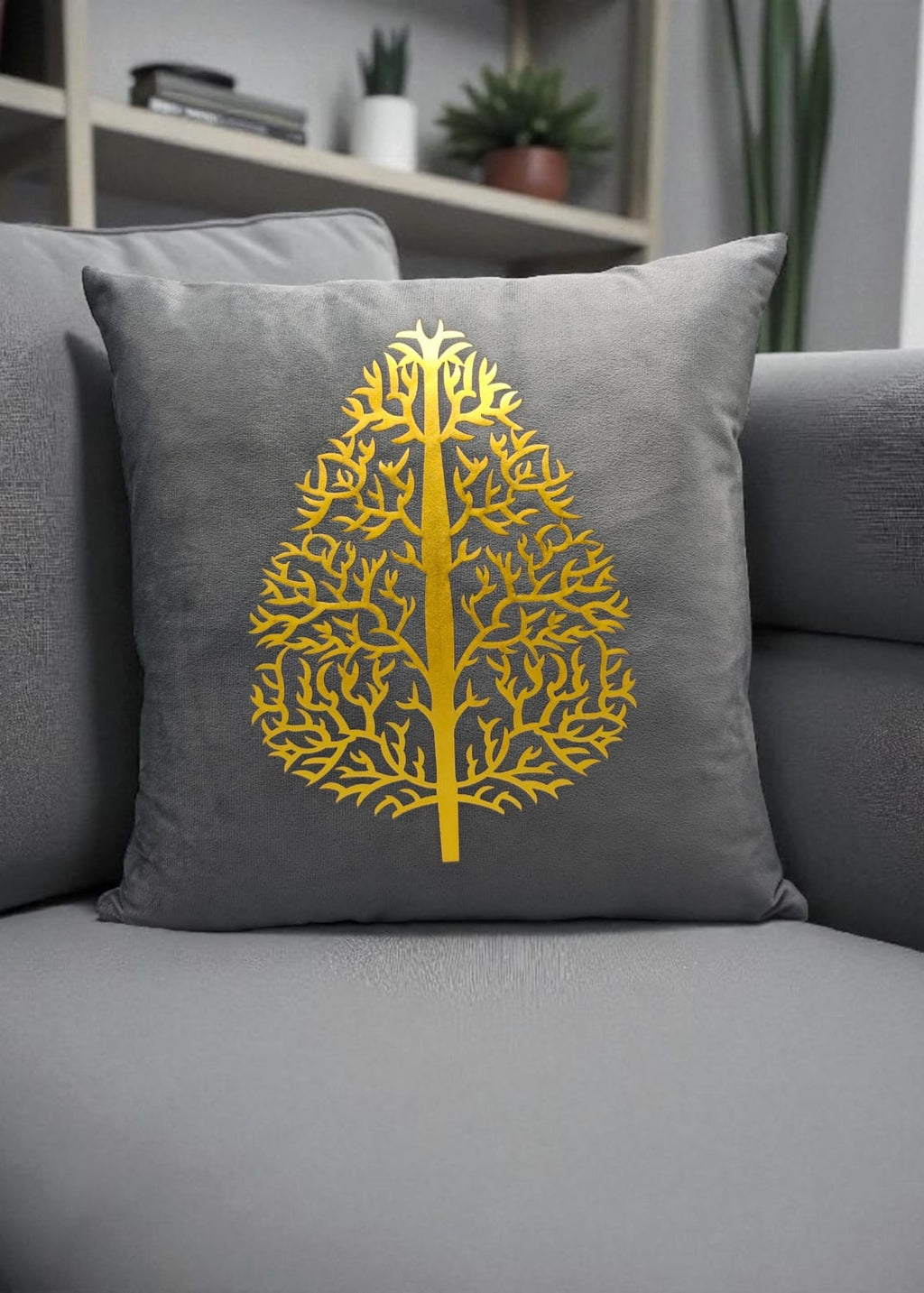 Gray pillow with a yellow tree design on a gray sofa