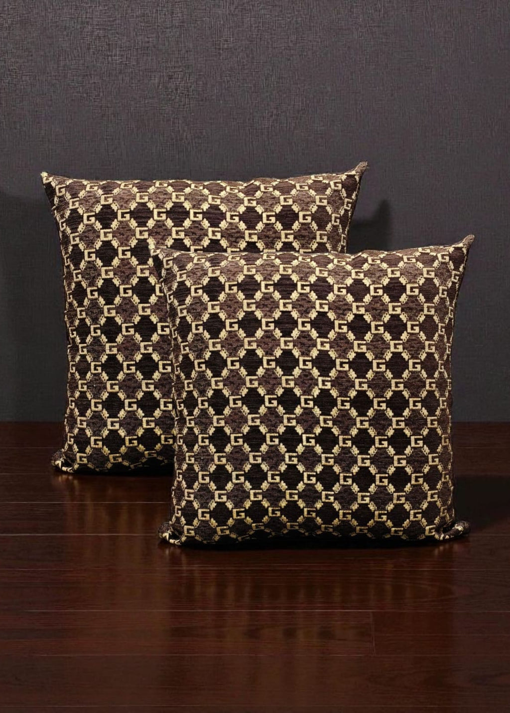 Two patterned pillows on a wooden surface with a dark background