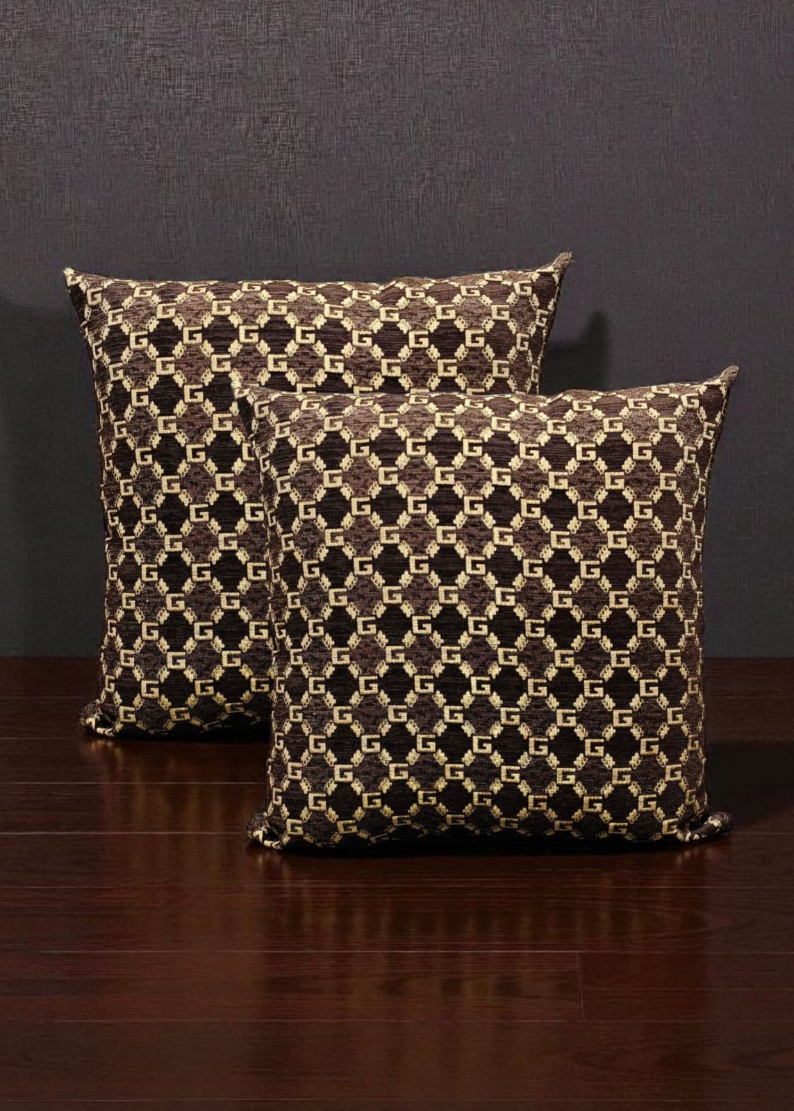 Two patterned pillows on a wooden surface with a dark background