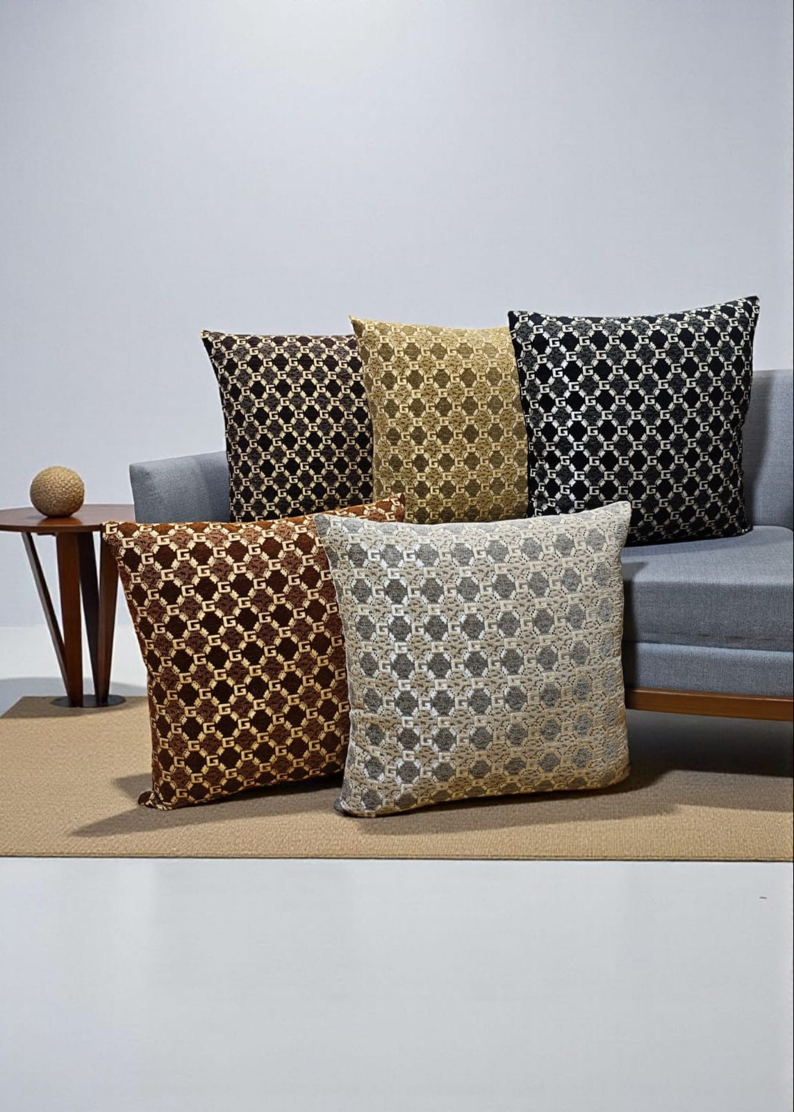 Decorative pillows with geometric patterns on a couch against a plain wall.